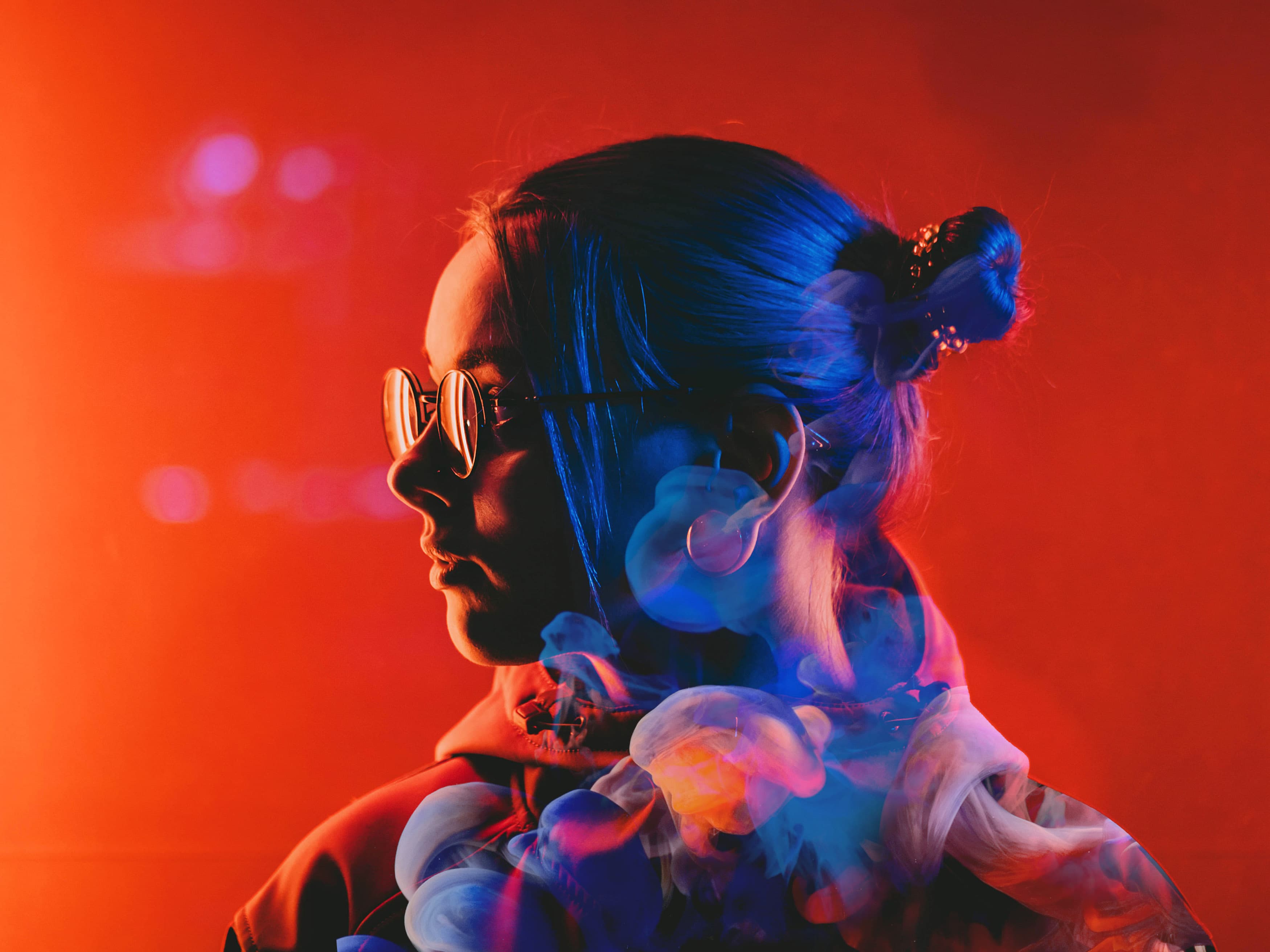 woman with glasses looking to the side